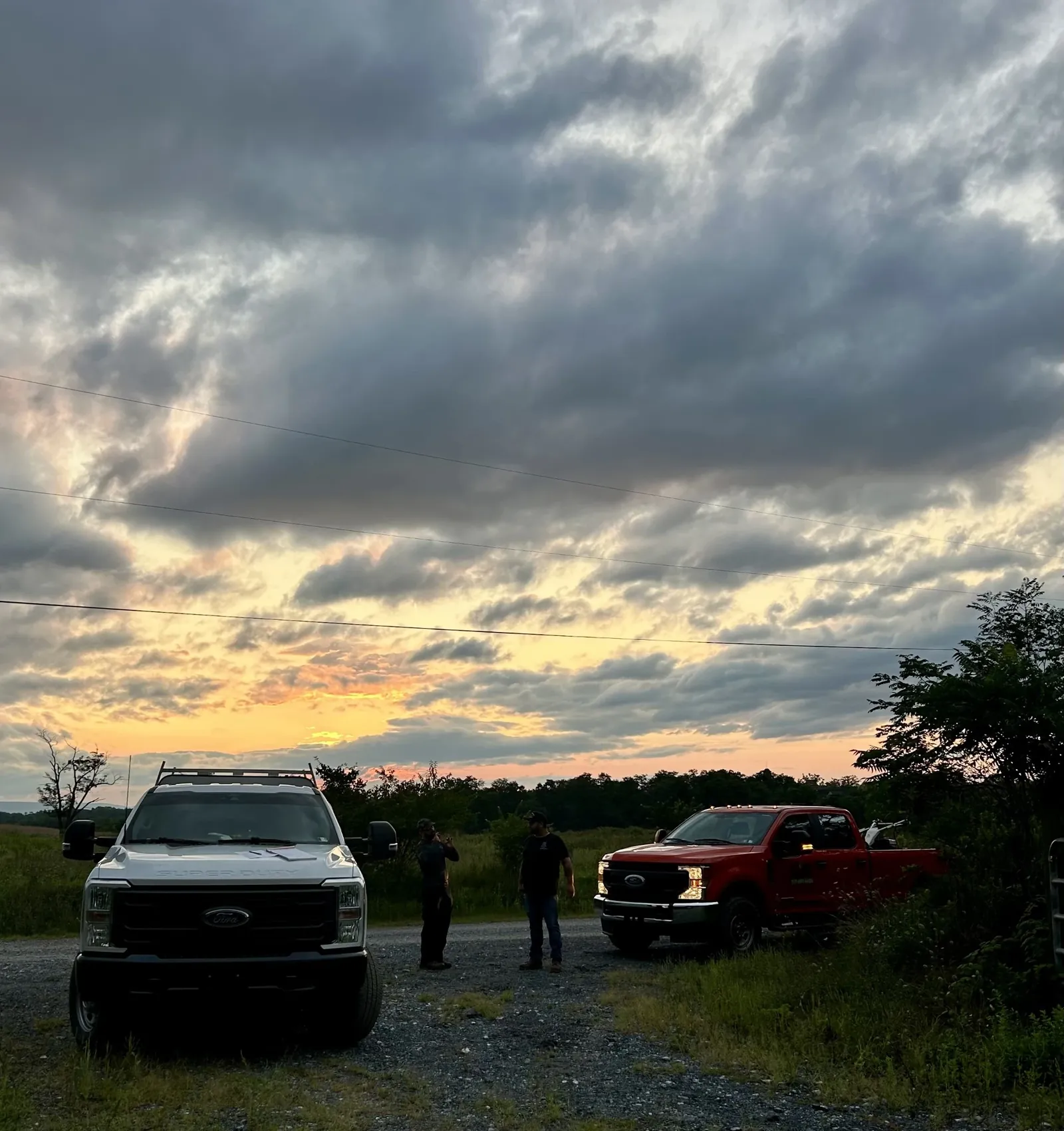 North Country work trucks parked at the end of the day under an evening sky